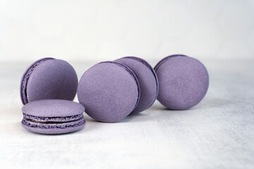 Obraz na płótnie Canvas Macaroons are delicious french cookies. Purple macaroons. A great gift idea for 8 March - International Women's Day. Copy space. Selective focus