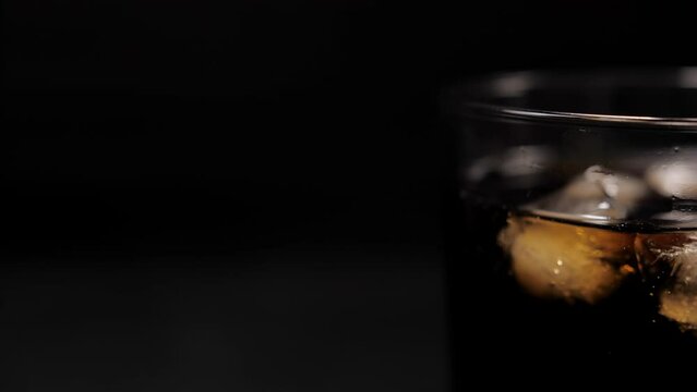 cola coke with ice cubes on cold glass slow motion 4k