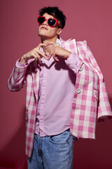 handsome guy self confidence pink plaid blazer fashion posing pink background unaltered