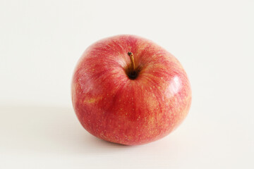 yellow and red apple on white table