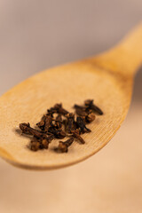 A clove in a spoon.
Spices on a spoon.