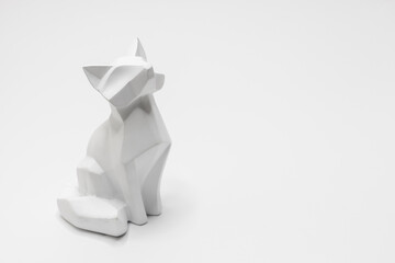 Cat figurine in origami style with a white background