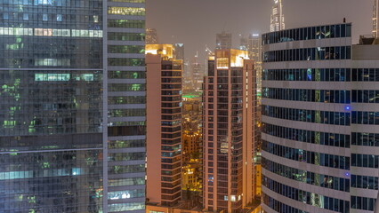 Fototapeta na wymiar Skyscrapers in Dubai Business Bay and financial district aerial night timelapse.