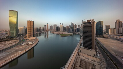 Obraz premium Cityscape skyscrapers of Dubai Business Bay with water canal aerial all day timelapse.