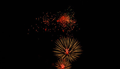 Colorful salute, great explodes in different colors in the night sky, beautifully dissolving in the air.