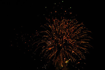 Colorful salute, great explodes in different colors in the night sky, beautifully dissolving in the air.