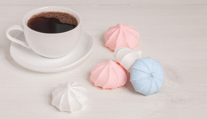 Fototapeta na wymiar Air meringue and a cup of black coffee. Place to copy.