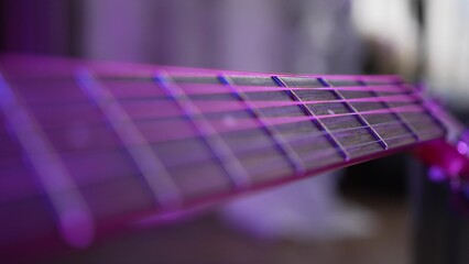 Acoustic guitar strings and fretboard on blurred background. Musical instrument for performing...