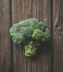 Close up of whole green broccoli at brown rustic wooden background. Organic vegetable. Healthy...