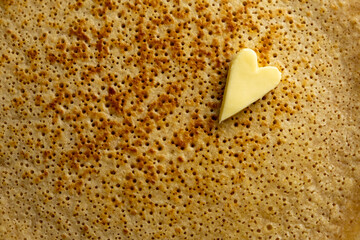 Pancake or blini with heart-shaped butter. Pancake week. Shrovetide. Russian, Ukrainian and...