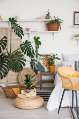 Stylish interior of modern bedroom with houseplants