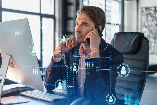 Businessman in suit has conference call to hire new employees for international business consulting. HR, social media hologram icons and interconnections over office background with panoramic windows