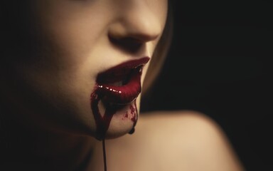 Woman with bloody mouth closeup photo