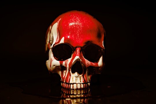 Blood stained skull against dark background closeup