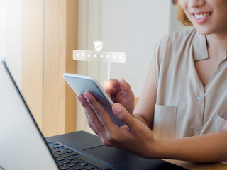 Two steps authentication concept. Virtual safety shield icon while access on phone with laptop for...