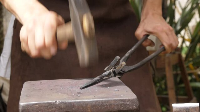 blacksmith hammering metal at medieval forge slow motion 4k