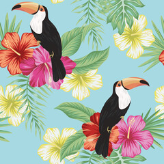 Tropical vintage toucan bird, red magenta yellow hibiscus flower, palm leaves floral seamless pattern blue background. Exotic jungle wallpaper. © good_mood