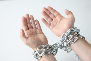 Man hands are tied with chain on white background