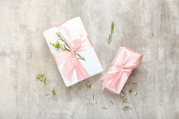 Beautiful spring composition with flowers and gift boxes on grunge background