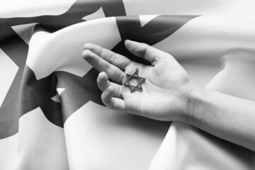 Hand with star of David on flag of Israel