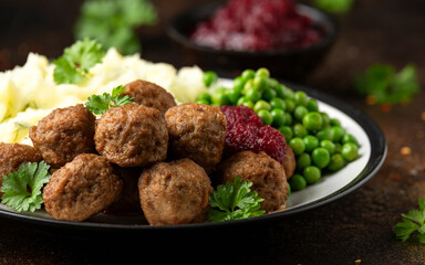 Homemade Swedish Meatballs with cranberry relish Sauce, potato mash and peas