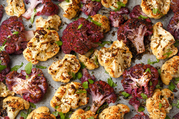 Roasted purple, white cauliflower with herbs on baking paper