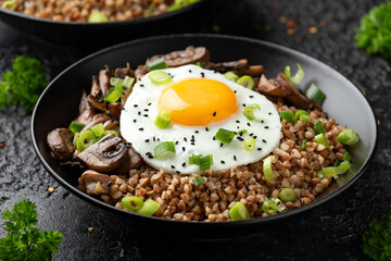 Bowl of Buckwheat with mushrooms, onion and egg. Healthy food