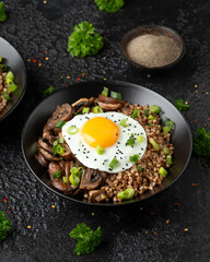 Fototapeta na wymiar Bowl of Buckwheat with mushrooms, onion and egg. Healthy food