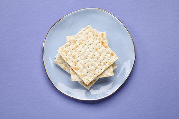 Plate with Jewish flatbread for Passover on color background