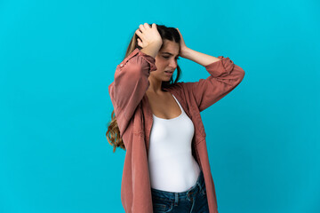 Young caucasian woman isolated on blue background stressed overwhelmed