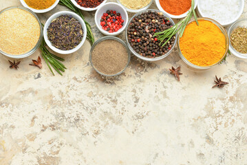 Bowls with different spices on grunge background