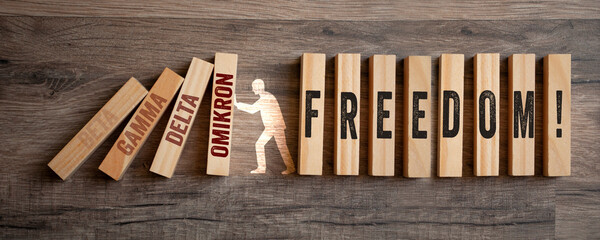 Pieces of wood with freedom day - metaphor for end of pandemic and endemic on wooden background	