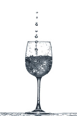 Glass of clean water with splash on white background