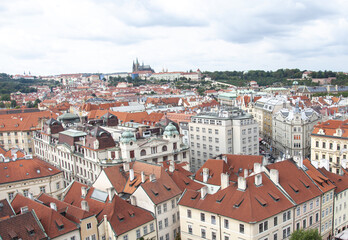 Fototapeta na wymiar Top view to red roofs skyline of Prague city, Czech Republic. Aerial view of Prague city with terracotta roof tiles, Prague, Czechia. Old Town architecture with roofs in Prague