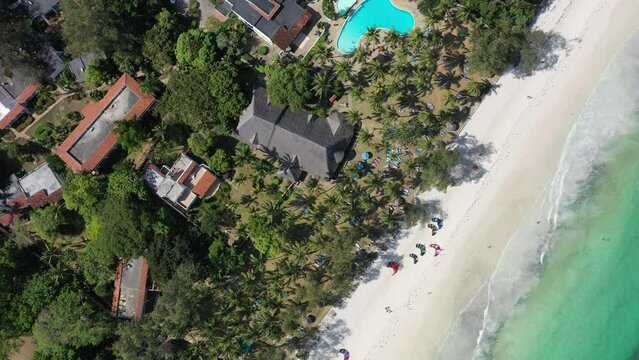 Aerial drone top down shot above hotel swimming pool in Diani beach in kenya Africa lodge 