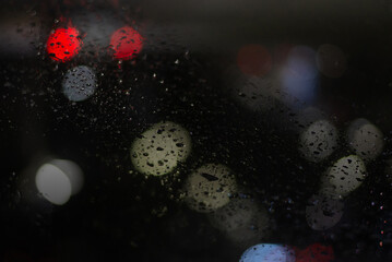 Blurred background with raindrops and lights.