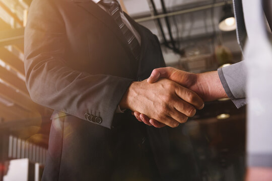 Handshaking of business person in office as teamwork and partnership