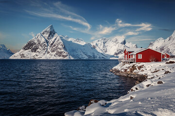 Amazing beautiful nature landscape of Lofoten Islands. Amazing winter scenery with snow covered mountains perfect blue sky and tipical red fishing huts, rorbu. popular travel location. Panorama - 488339092