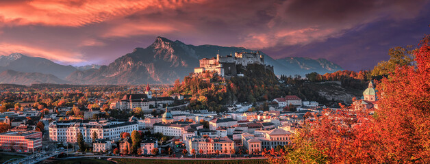 Colorful evening cityscape. Panoramic view on historic city of Salzburg with famous Hohensalzburg Fortress. Wonderful autumn landscape with picturesque sky. Softlight effect. Salzburger Land, Austria