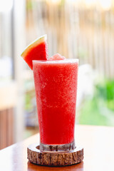 Watermelon smoothie served with piece of watermelon