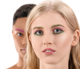 Fashionable young couple with unusual eyebrows on white background