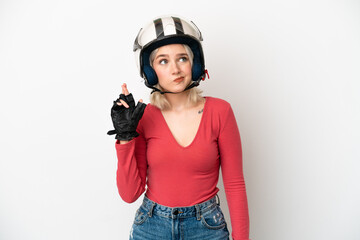 Young caucasian woman with a motorcycle helmet isolated on white background with fingers crossing and wishing the best