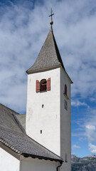 La Crusc. The bell tower of the church. Typical Tyrolean church tower. General context. Badia, Alto Adige, South Tyrol, Italy