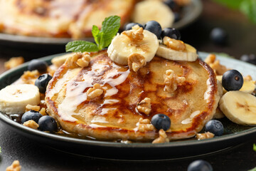 American pancakes with banana, blueberry, walnut and honey. Healthy morning breakfast