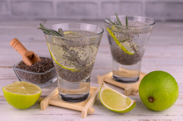 Water with chia seeds and lime with rosemary sprig.