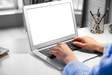 Woman working with modern laptop on light table
