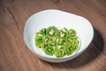 diced kiwifruit in a white bowl on a wooden table