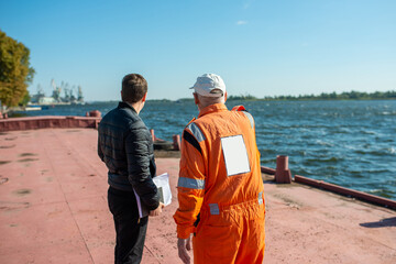 sailor communicates with the superintendent on the deck in the port