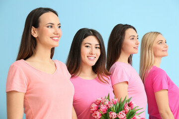 Beautiful women with bouquet of flowers on blue background. International Women's Day celebration