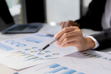 Business women are looking at the company's financial documents to analyze problems and find solutions before bringing the information to a meeting with a partner. Financial concept.